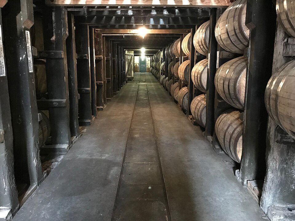Inside a bourbon rickhouse. These tall wooden warehouses swing from hot summers to cold winters, an…