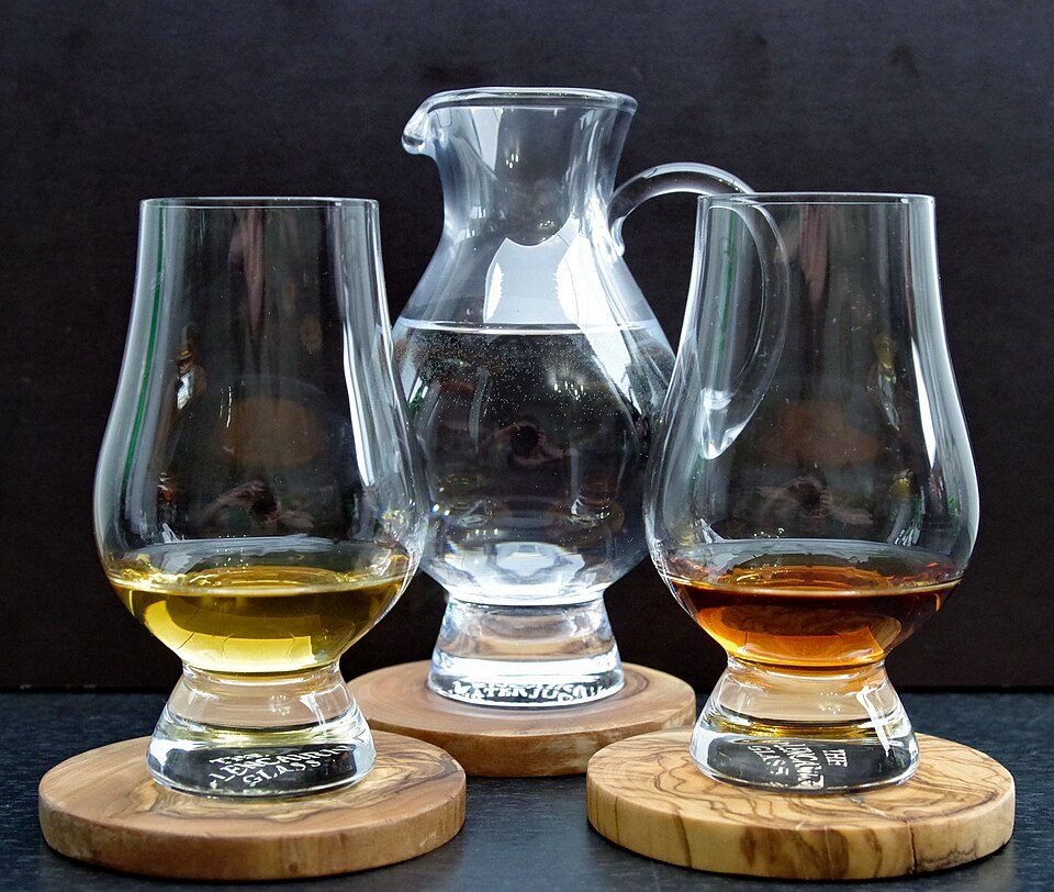 Two Glencairn glasses with a water jug. A few drops of water, added slowly, can open up a whisky.